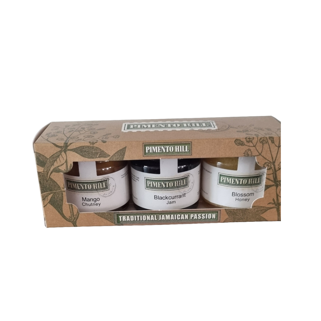 Close-up of Pimento Hill Jamaican gift set showing three artisan jars of mango chutney, blackcurrant jam and blossom homey 