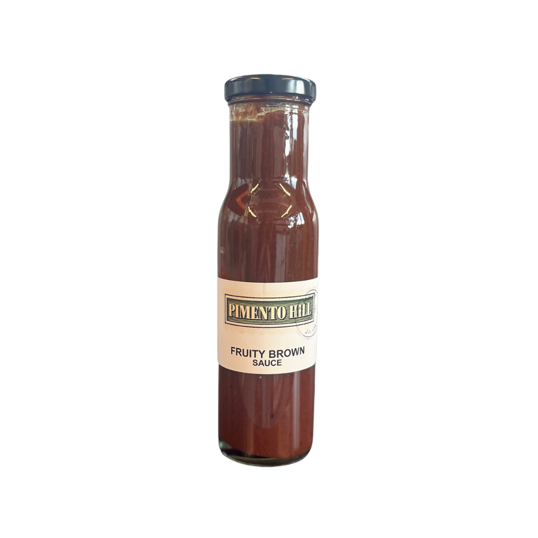 Bottle of Pimento Hill Jamaican Fruity Brown Sauce with cream label and rich dark brown sauce inside a glass bottle.